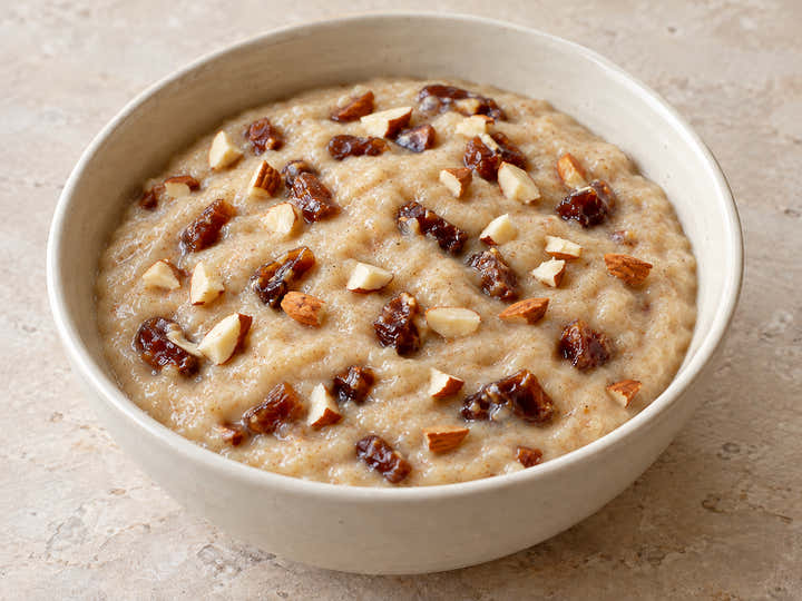 Dates and Almond Sprouted Porridge in an ivory bowl