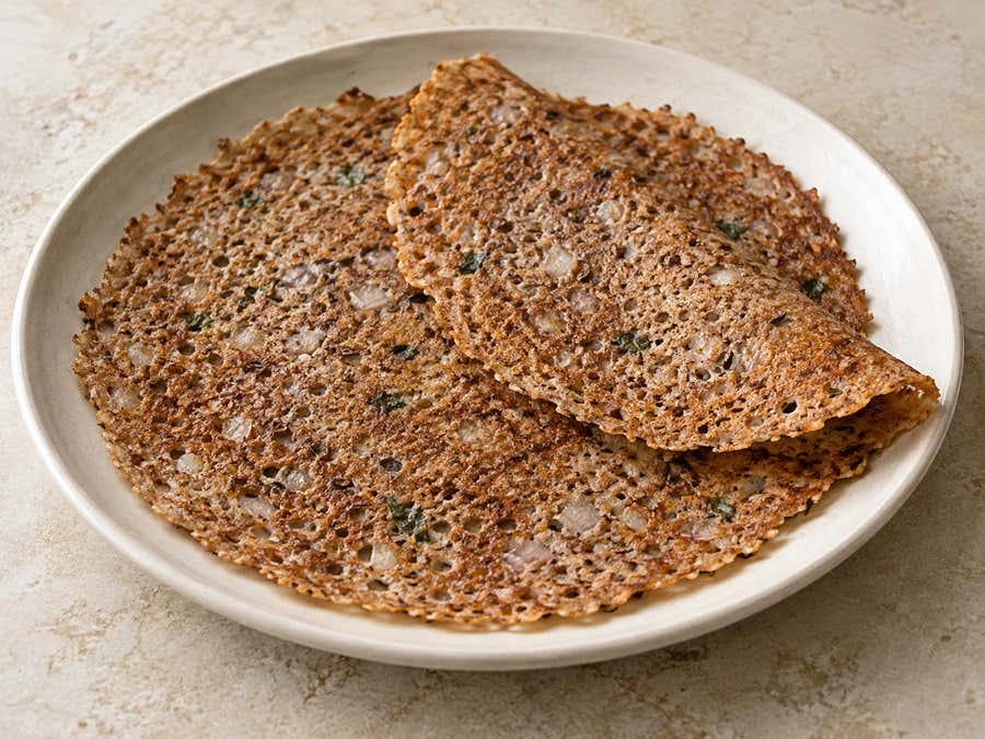 Thin crisp black wheat dosas with onion and cumin